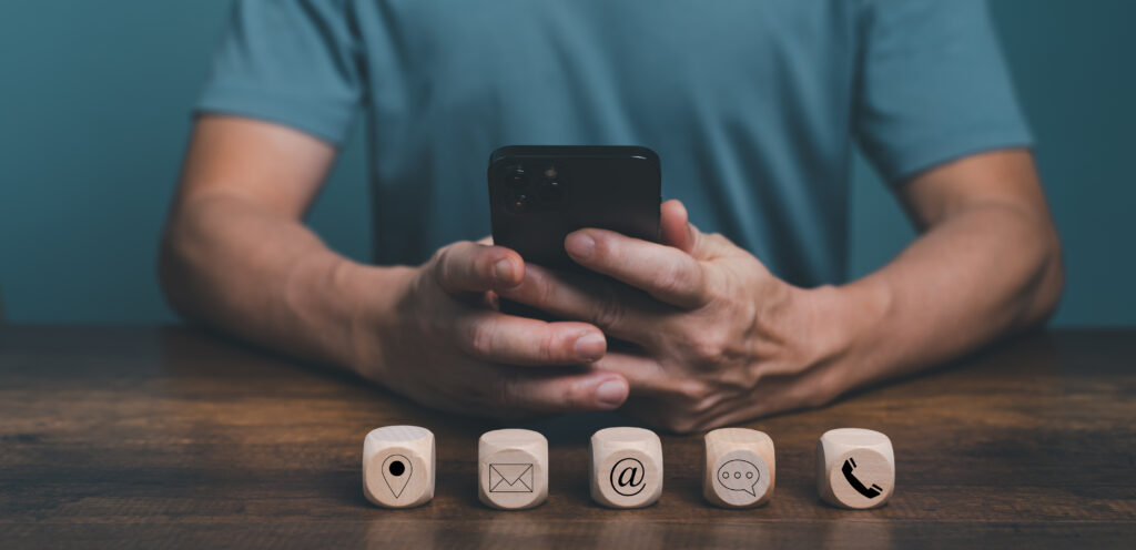 The current image has no alternative text. The file name is: vecteezy_contact-us-concept-man-hand-holding-mobile-phone-for_13298260-scaled.jpg